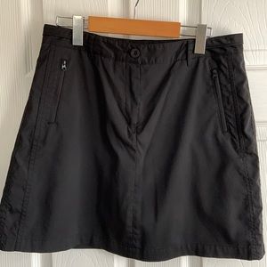 Black skort for golf/ casual wear. Poly/spandex blend. Lightweight breathable